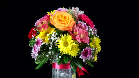 flower bouquet spinning in black background wide shot