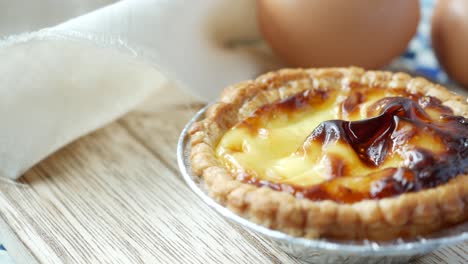 a egg tart on a wooden board,