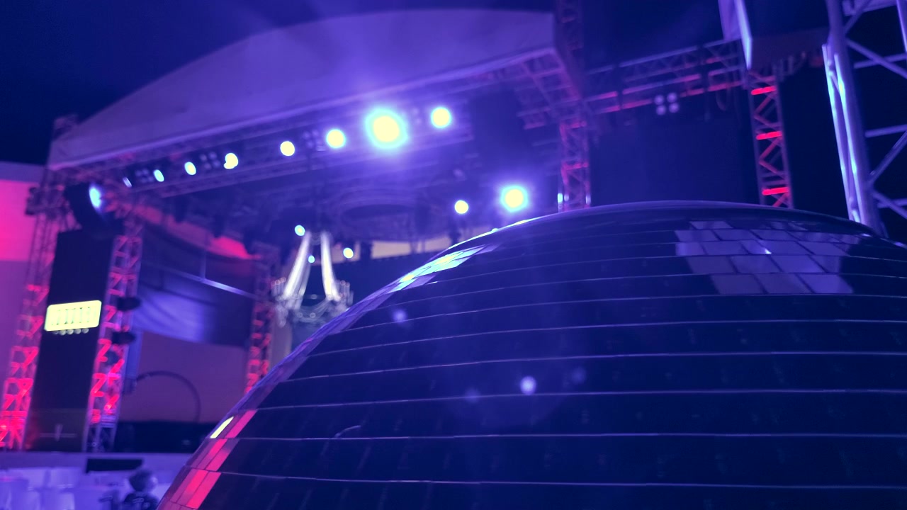 Rotating Disco Ball on Stage with Vibrant Lighting