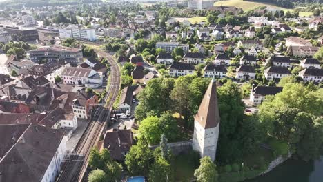 aerial view of olten with historic tower, riverfront, and surrounding residential area in solothurn, switzerland