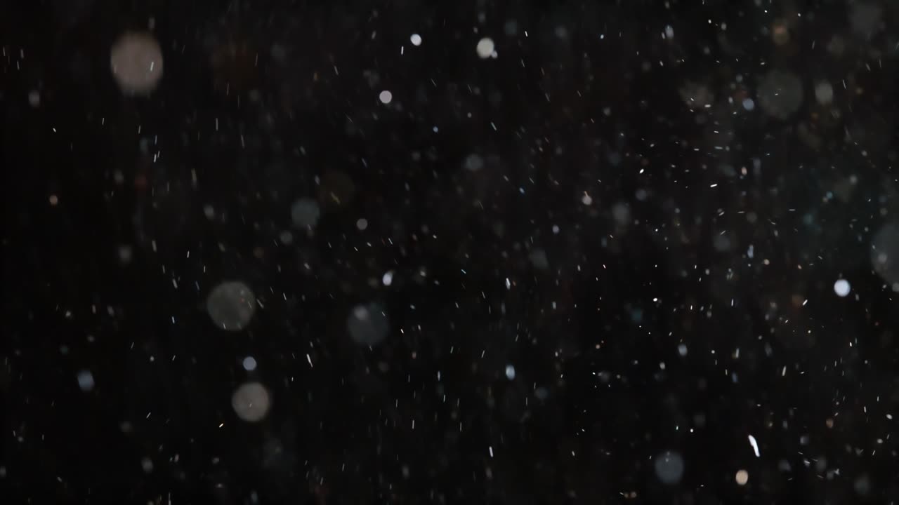 Floating abstract particle bokeh on dark background