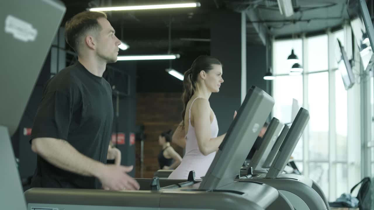 People Exercising on Treadmills in a Gym