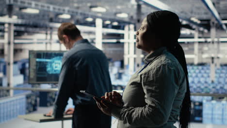 software developers monitor server hub activity using tablet