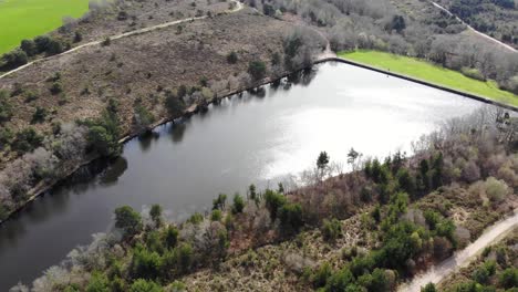 Aerial-View-Of-Squabmoor-Reservoir-Located-In-Woodbury-Common,-Devon