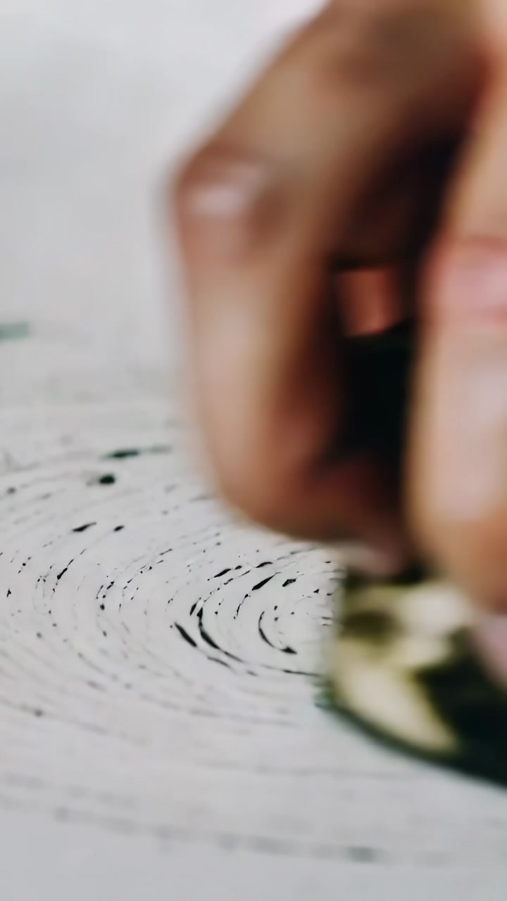 Hand Rubbing a Textured Ink Block to Create Circular Patterns