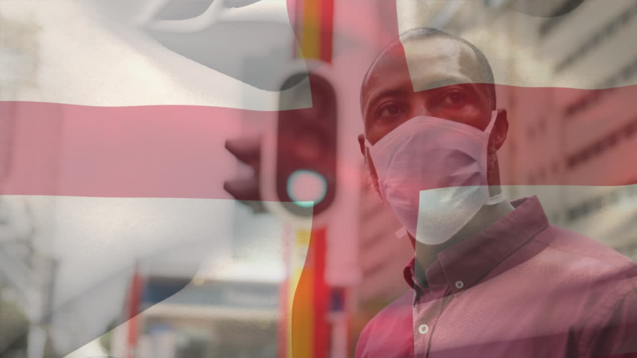 animación de la bandera de inglaterra ondeando sobre un hombre afroamericano con máscara facial en la calle de la ciudad