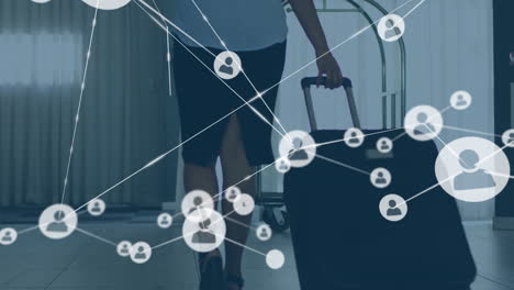 animation of network of connections with icons over african american woman with suitcase