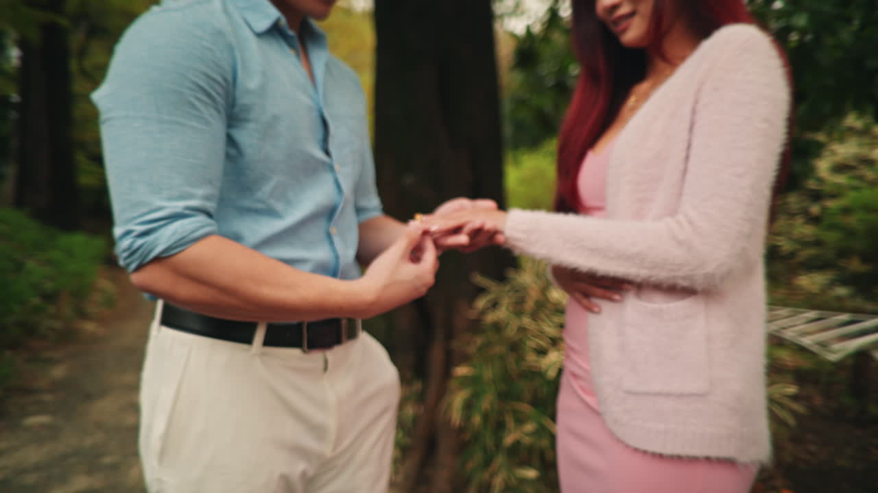 A couple getting engaged in a park