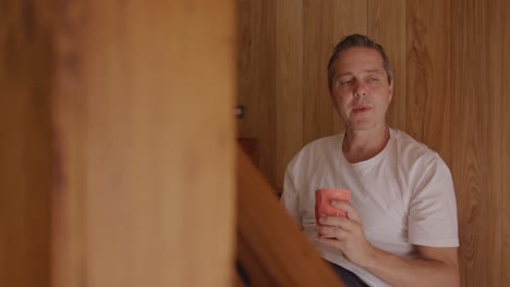 Man-sitting-on-the-stairs-at-home