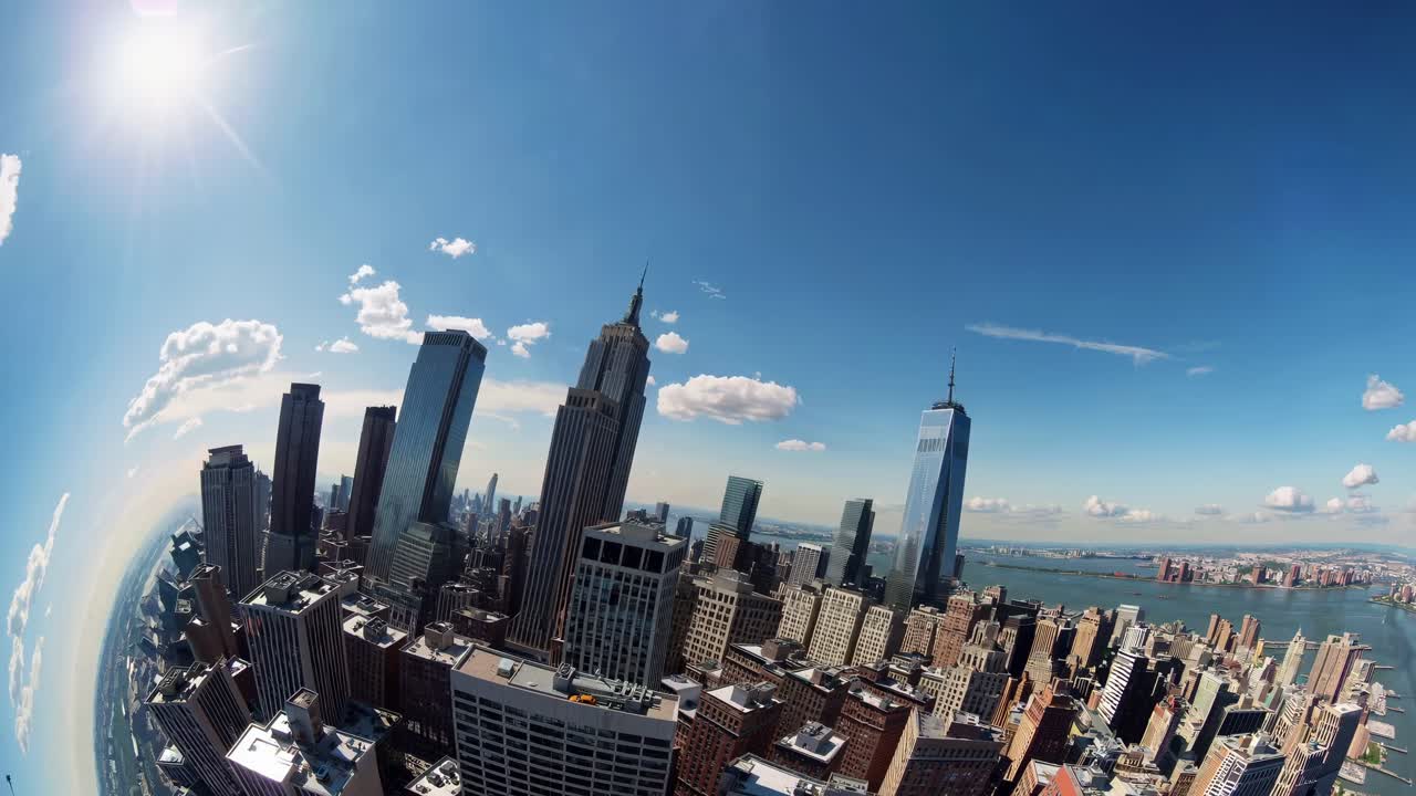 Fisheye lens captures a dynamic cityscape from a high angle, showcasing skyscrapers under a bright