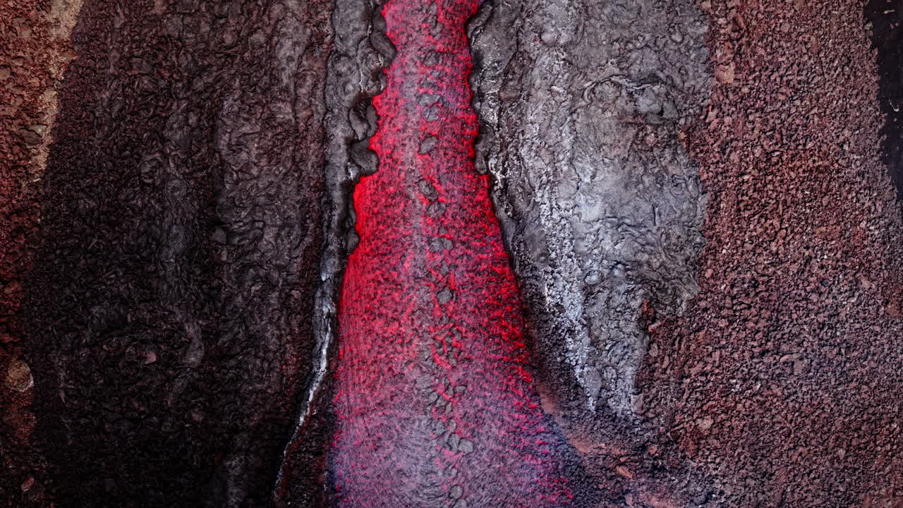 Glowing lava flowing from Etna volcano, Sicily, intense and striking view