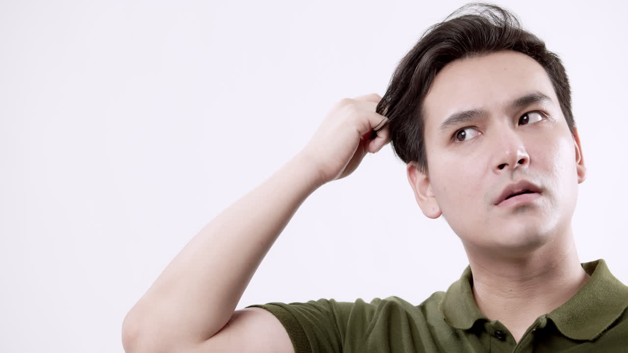 A man enjoys a calming grooming moment reflecting self-care in a bright studio setting.