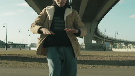 young man dancing hip hop outdoors