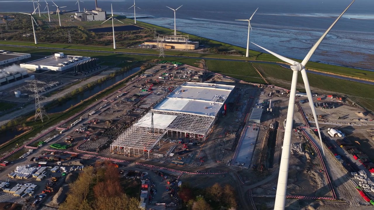 Aerial drone view of Eemshaven datacenter complex expansion, showing hyperscale infrastructure for big data and machine learning.