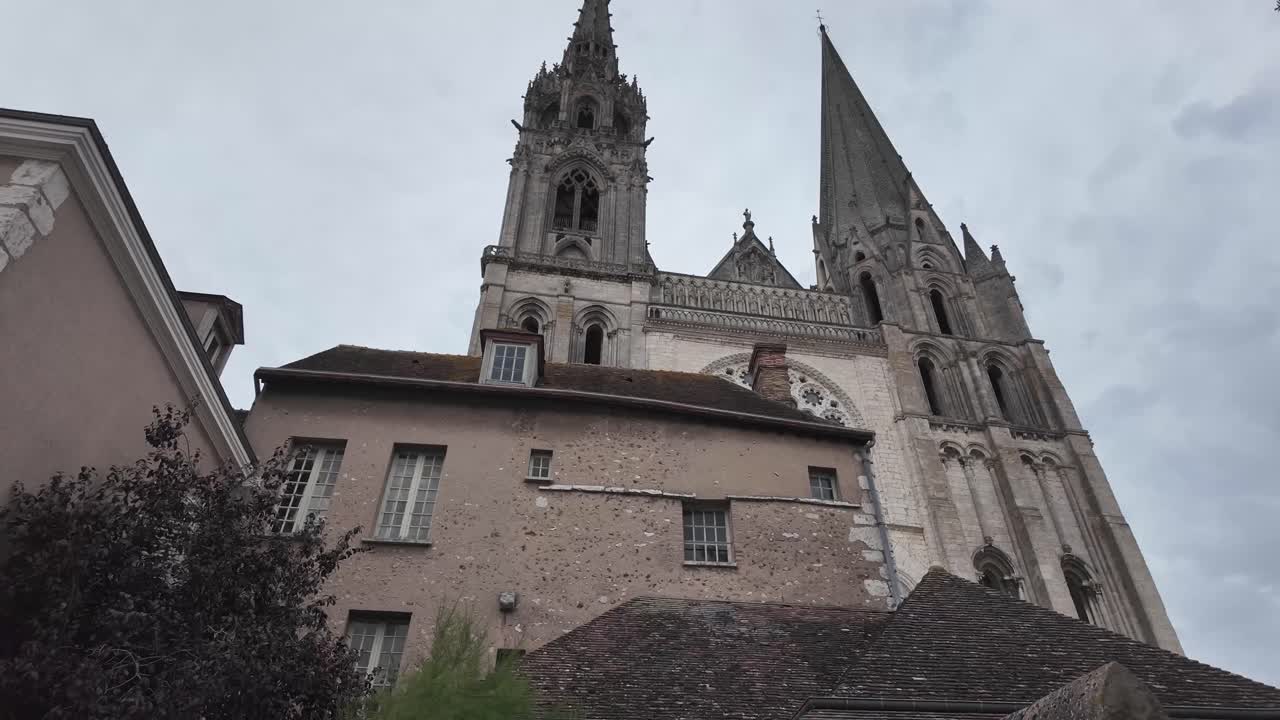 Historical monumental Cathedral revealing behind houses in Chartres, France