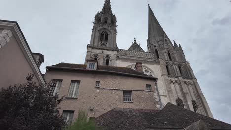 historical monumental cathedral revealing behind houses in chartres, france