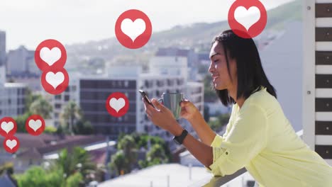 animation of social media red heart icons over biracial woman using smartphone
