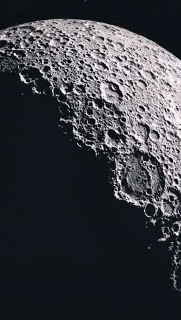 vertical shot of zooming in to the dark side of the moon as the sun slowly reveals the craters