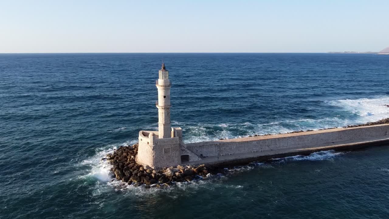 Drone shot of iconic lighthouse in old Venetian harbour reveals city of Chania, Mediterranean sea