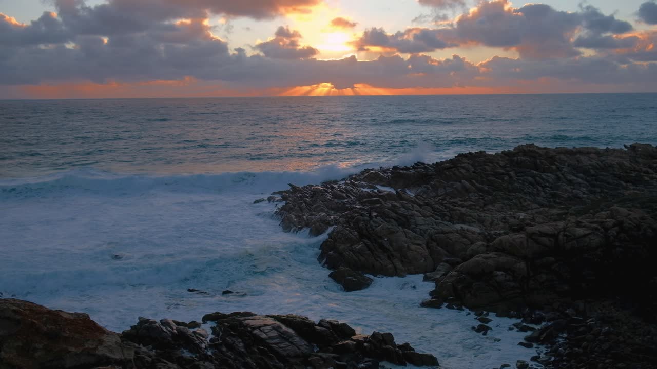 Light rays at sunset over the ocean at Injidup beach Western Australia ...