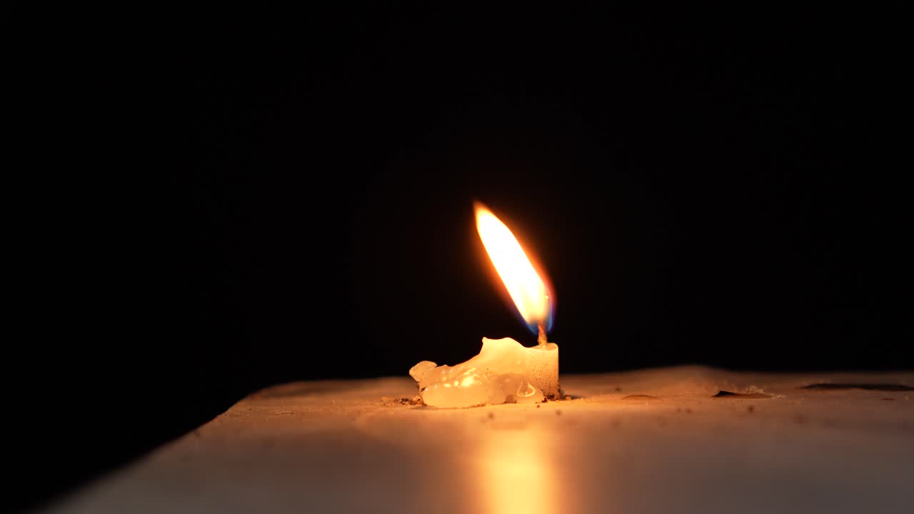 The candle flame is burning