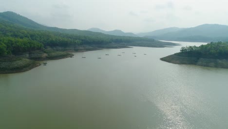 4k-Aerial-View-of-Tranquil-River-Surrounded-by-Mountain-and-Clear-Sky-in-Thailand