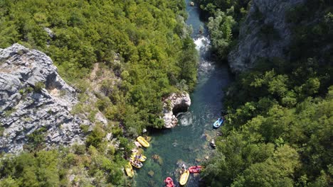 People-cliff-jumping-off-a-Rock-after-white-water-rafting-on-scenic-Cetina-River-in-omis,-Croatia