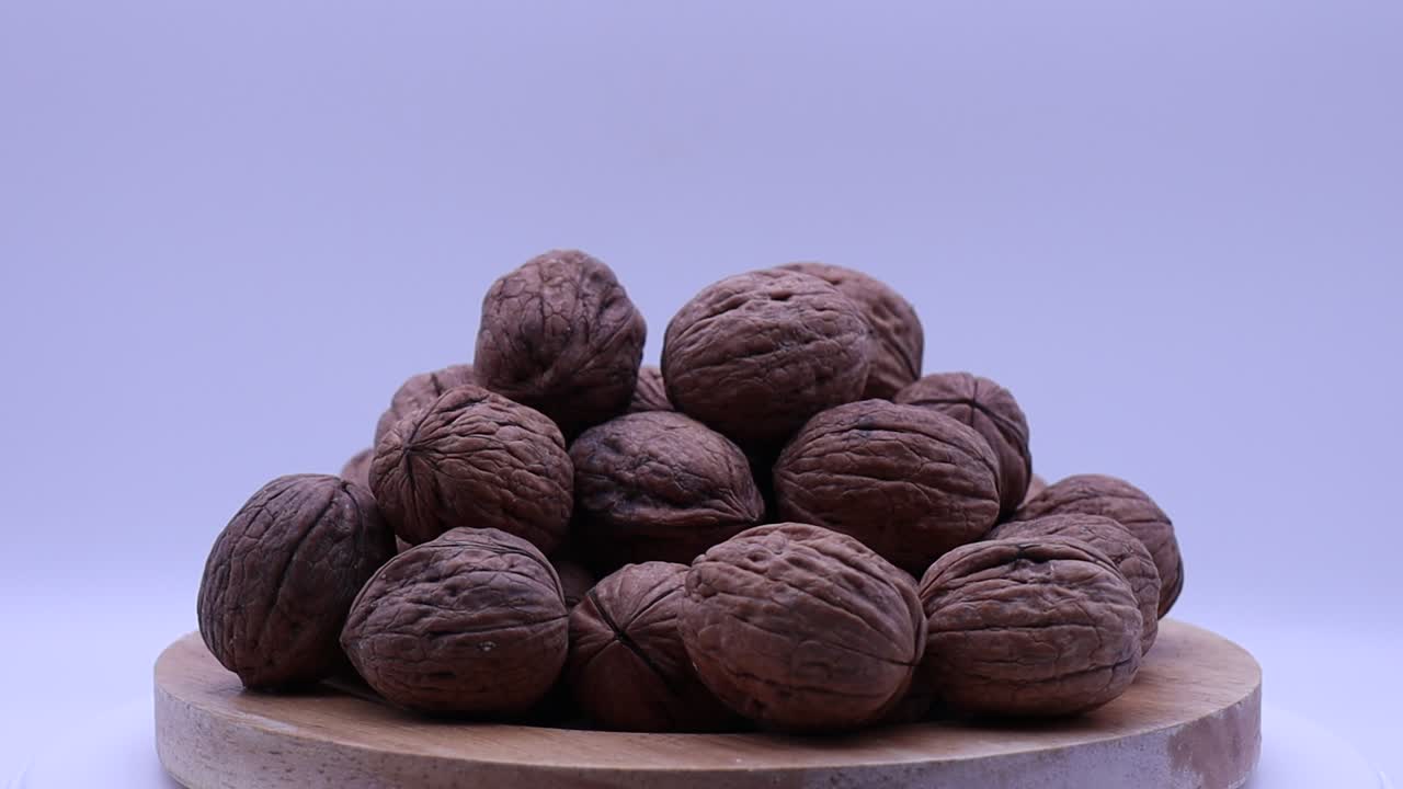 Walnuts rotating on a turntable. Turning walnuts