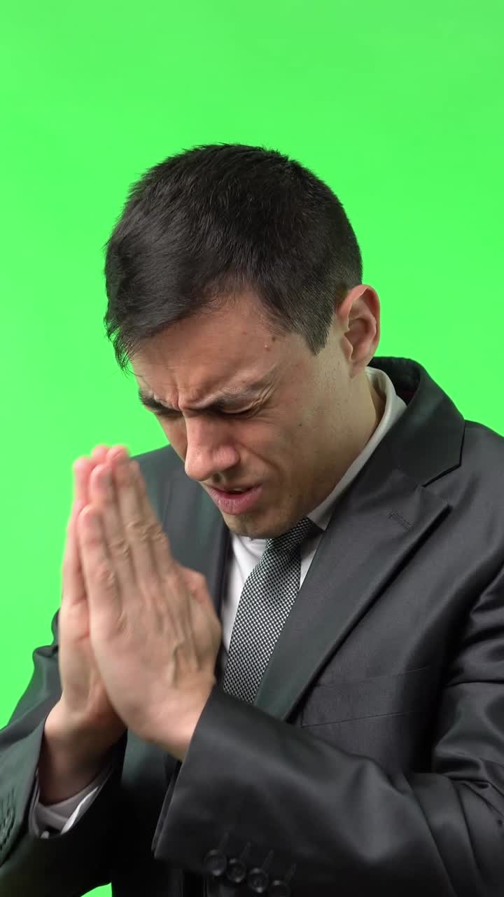 Man in Suit Praying or Pleading on Green Screen