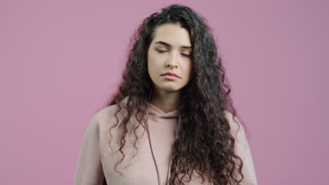 woman with curly hair in a hoodie