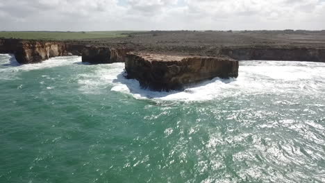 AERIAL-RISING-REVERSE---Waves-pounding-the-eroding-Australian-coastline