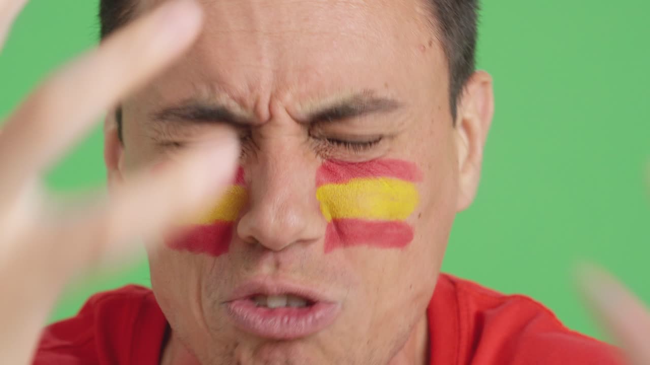 Man with spanish national flag upset with a football referee