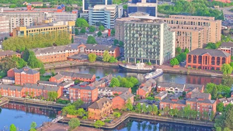 aerial view of waterside buildings along canal at media city uk district, salford quays manchester