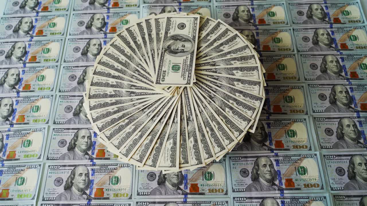 Cash money background. Circle with hundred dollar bills spin on the background of american 100 dollar banknotes. Successful business.