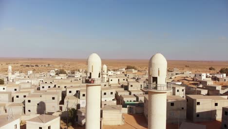 aerial shot of two mosques at palestine near gaza in the desert at an empty city.