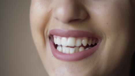 toothy smile of dark haired young female model