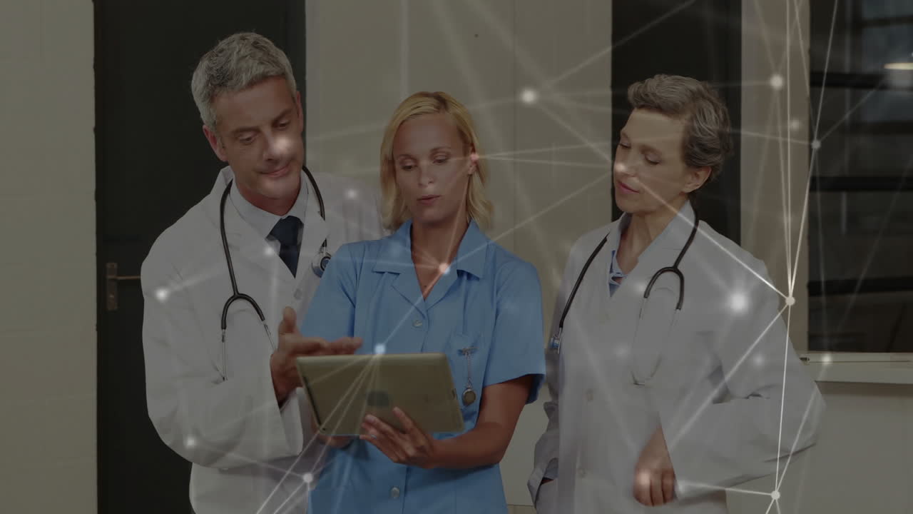 Doctors discussing patient data on tablet with network connections animation overlay