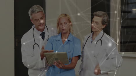 doctors discussing patient data on tablet with network connections animation overlay