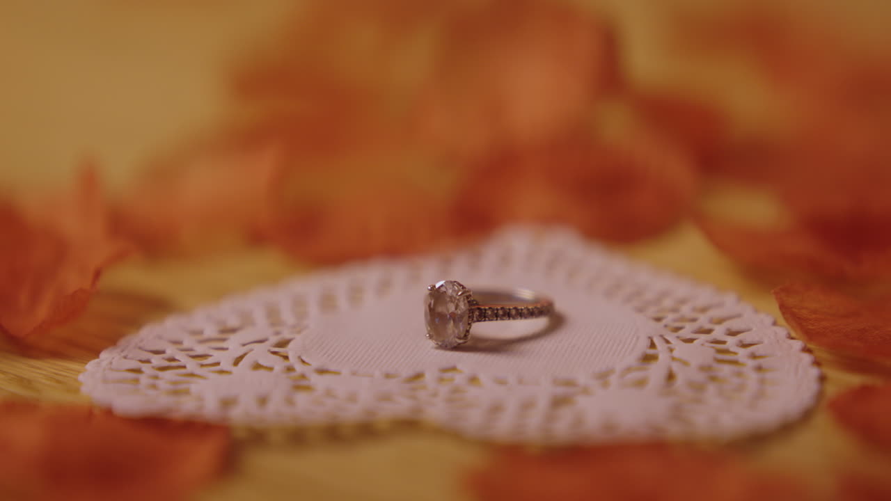 Diamond Ring on Heart-shaped Doily with Rose Petals