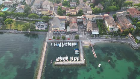 stunning turquoise water by the cisano harbour on lake garda at bardolino, italy