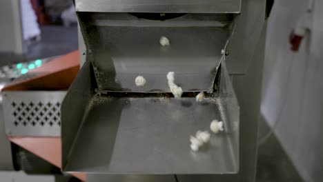 shot of a popcorn falling from a conveyor