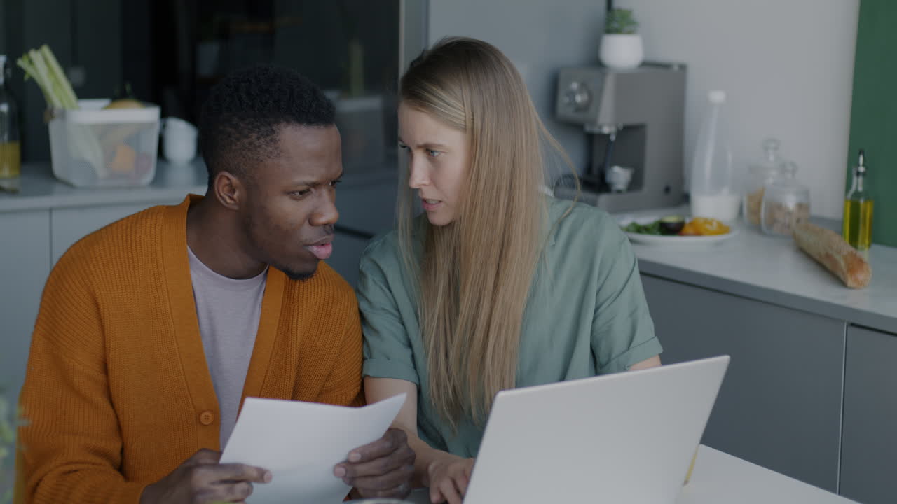 Couple Working Together on Documents in Kitchen