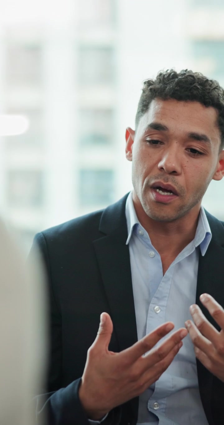 Professional Man Discussing Business Strategy in Office Meeting