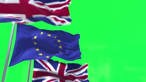 la bandera de la unión europea ondeando entre dos banderas del reino unido aisladas en un fondo de pantalla verde