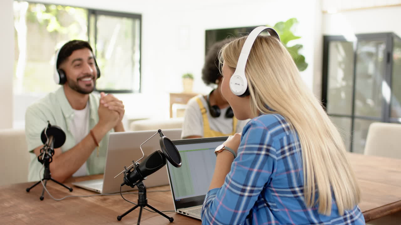 Recording podcast, friends using laptops and microphones, enjoying conversation