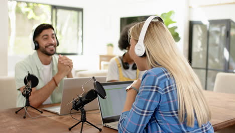 recording podcast, friends using laptops and microphones, enjoying conversation