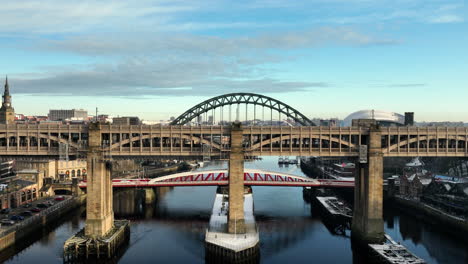 beautiful sun sets over the high level bridge as we lift up to reveal the tyne bridge in newcastle upon tyne