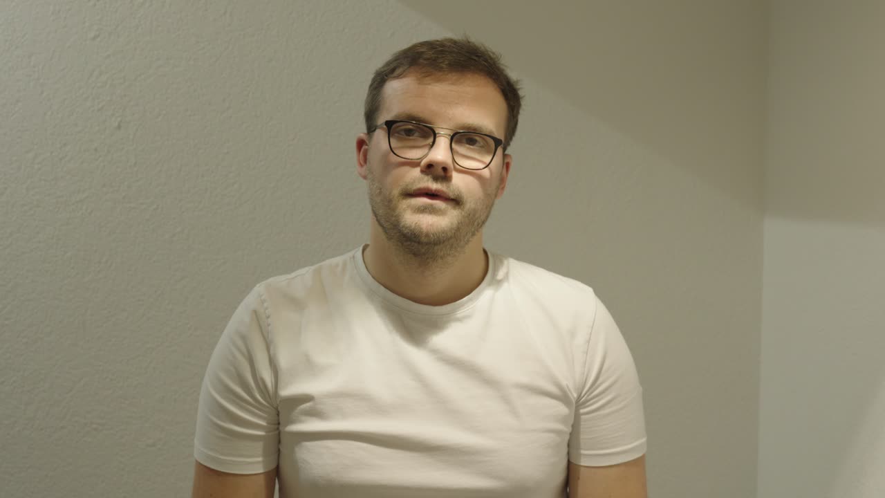 A man speaks in a flat, expressionless tone — example of monotone communication, poor presentation skills, and unengaging speech style