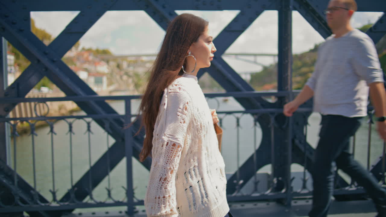 Stylish model walking overcrowded sunny iron construction. Woman strolling alone
