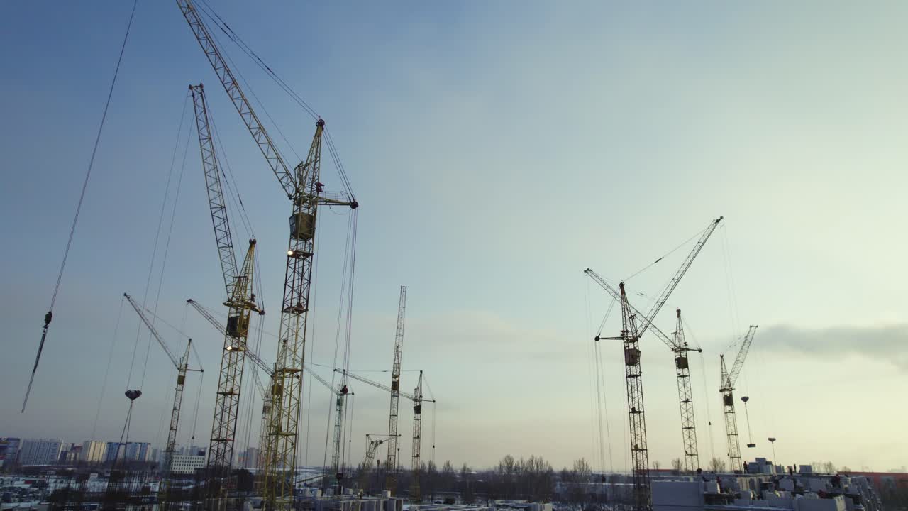 Construction Site with Cranes in a Cityscape during Winter